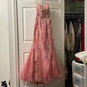 A long pink mermaid tale dress with wraps around straps